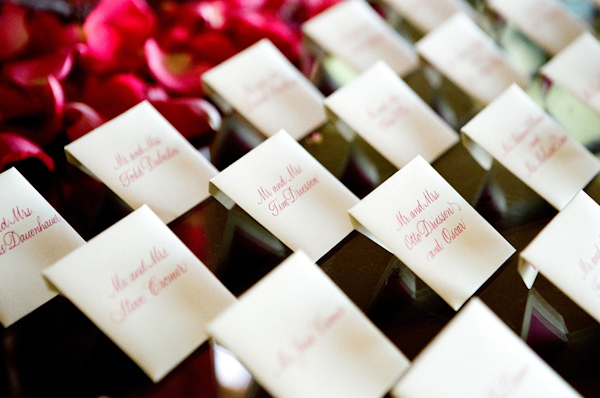 pink calligraphy wedding escort cards photo by Yvette Roman Photography